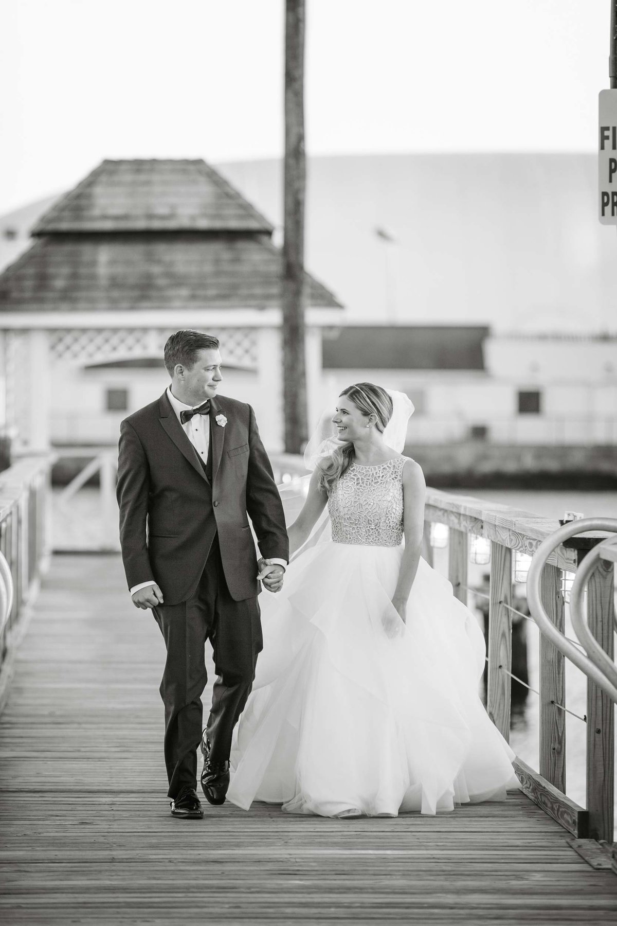 Bride and groom walking the docks of Bridgeview Yacht Club