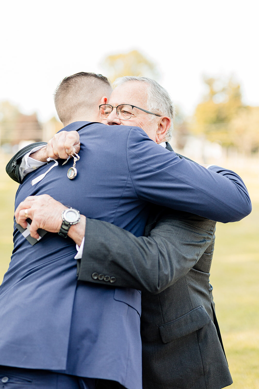 groom getting a hug from a family member