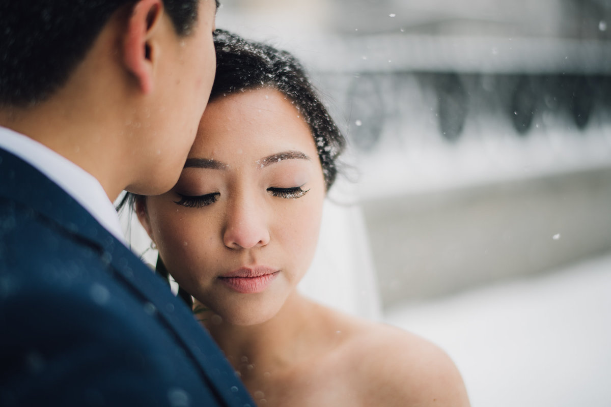 Bride and groom having their portraits taken during a snowy philadelphia wedding in Old City