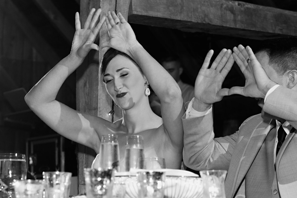 The bride and groom throw up the sign for JayZ at their Skinner Barn in Vermont fall wedding