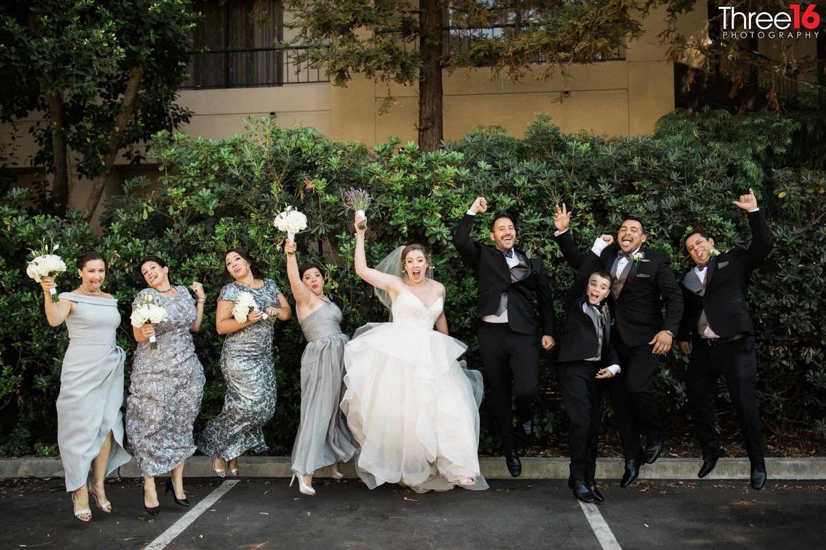 Bridal Party jump for joy to celebrate