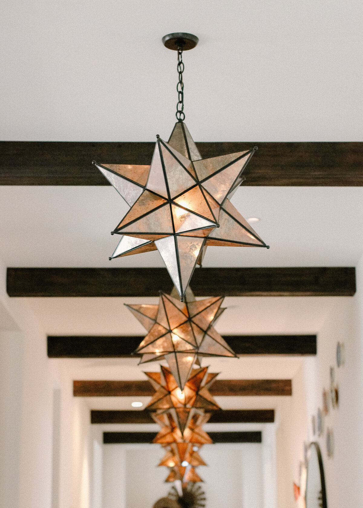 star glass pendants in spanish style house hallway