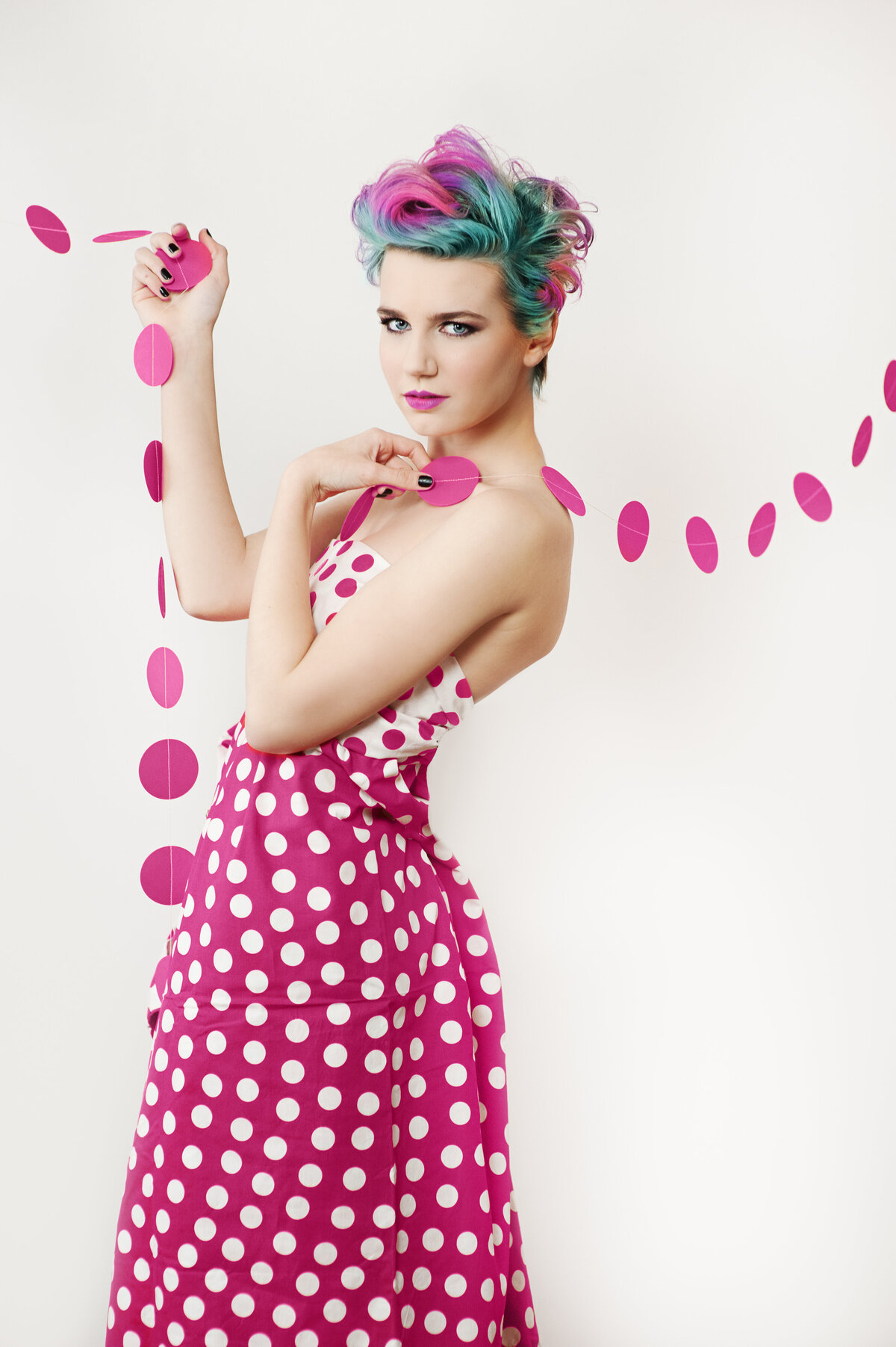 senior girl in polka dot dress with rainbow hair