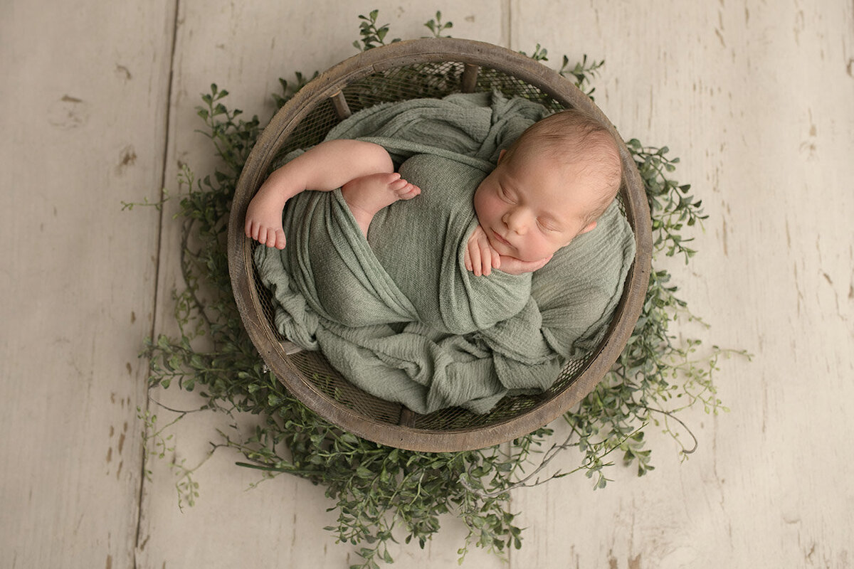 Newborn baby in green blanket