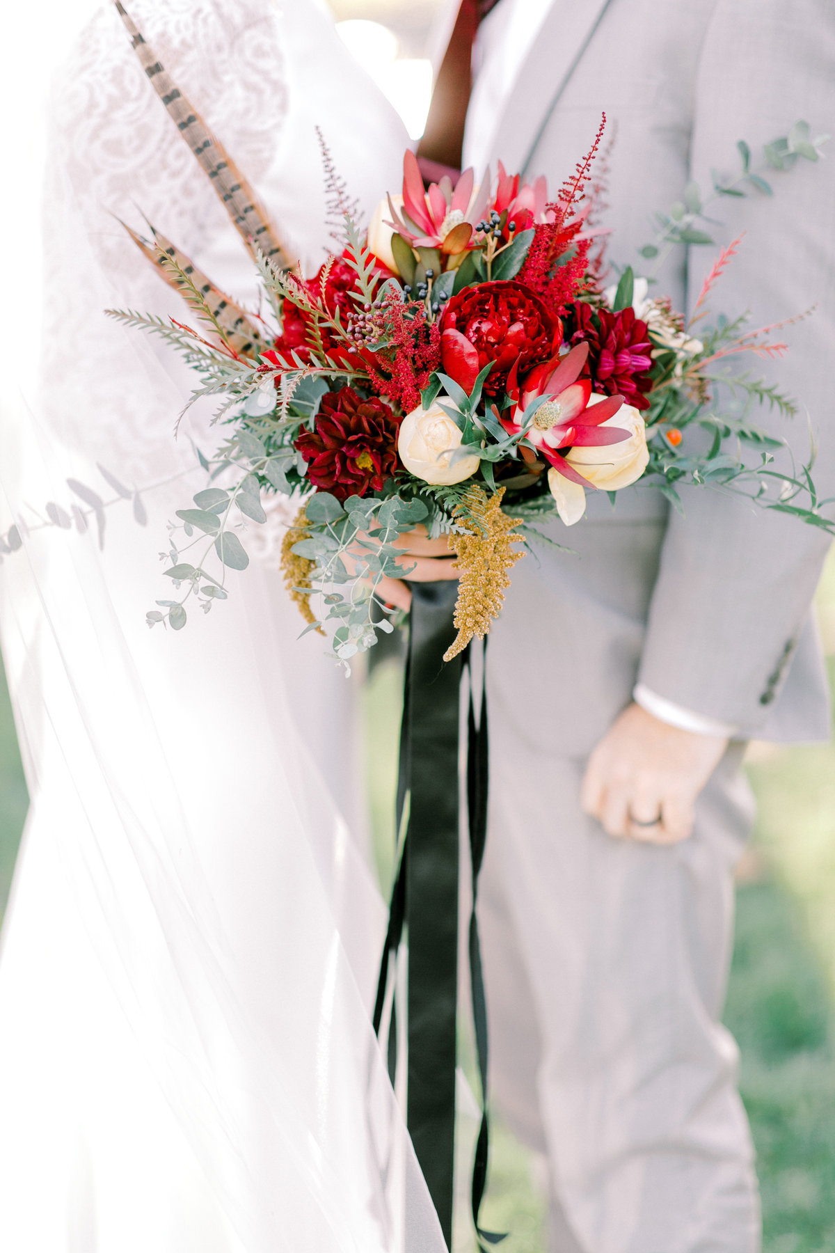 fall themed bridal bouquet with pheasant feathers