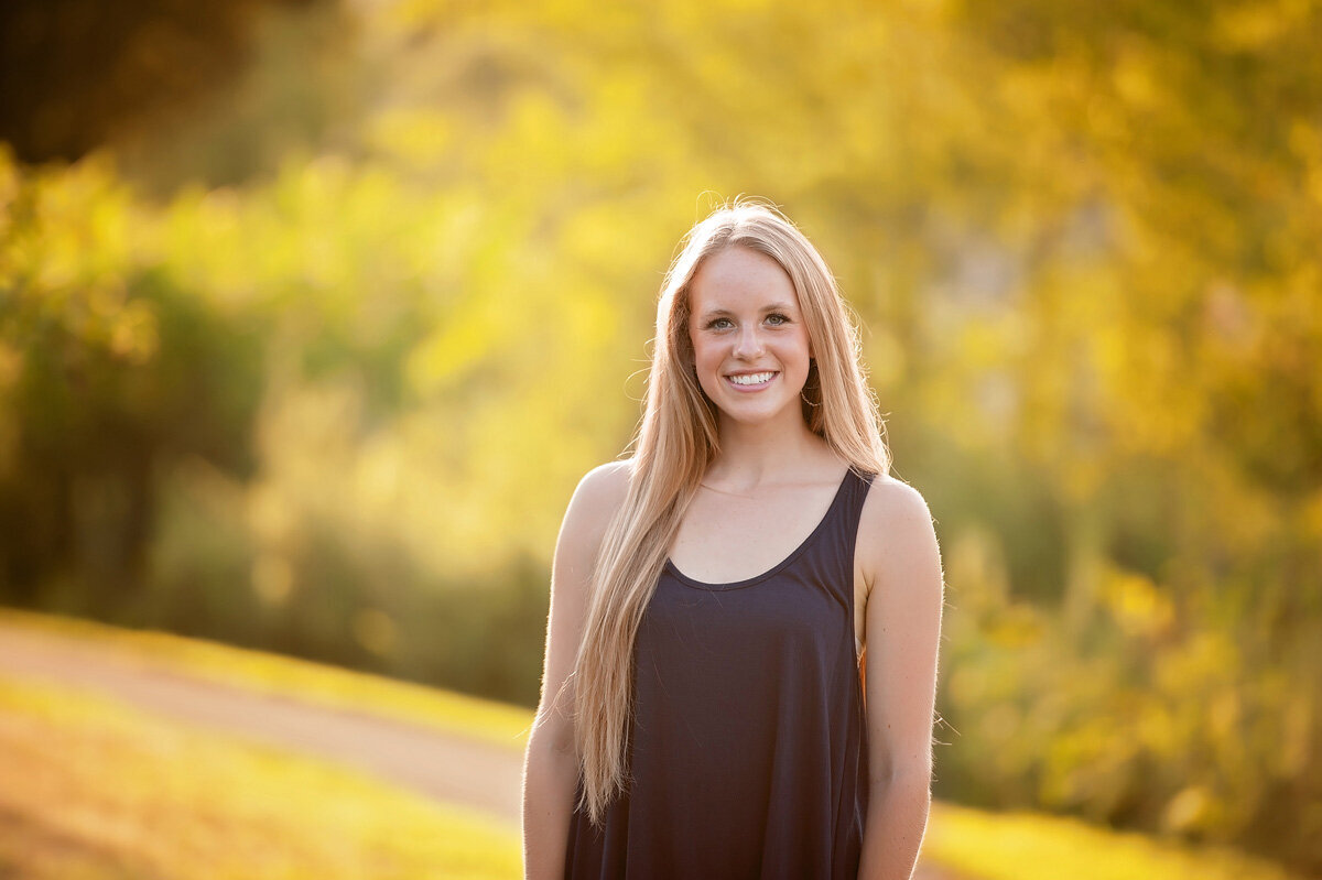 Senior session of young woman standing outside