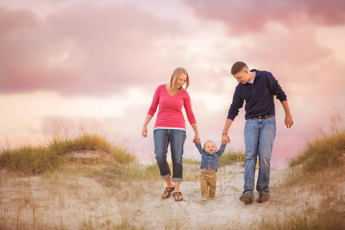 A sunset with pink colors during a family picture session in Laramie for a family with an adorable little boy.