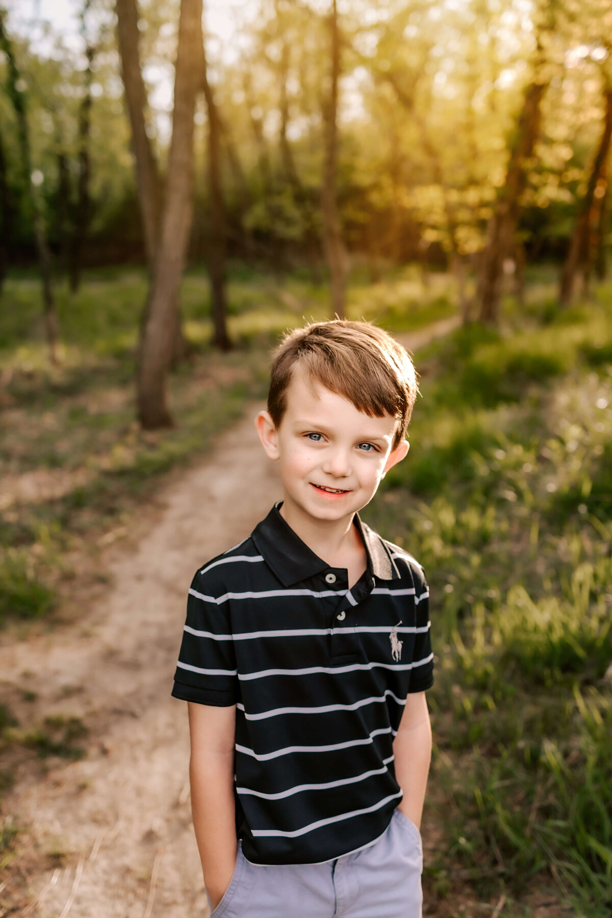An adorable little boy smiling so cute for his family photos in the Cliff Cave park.