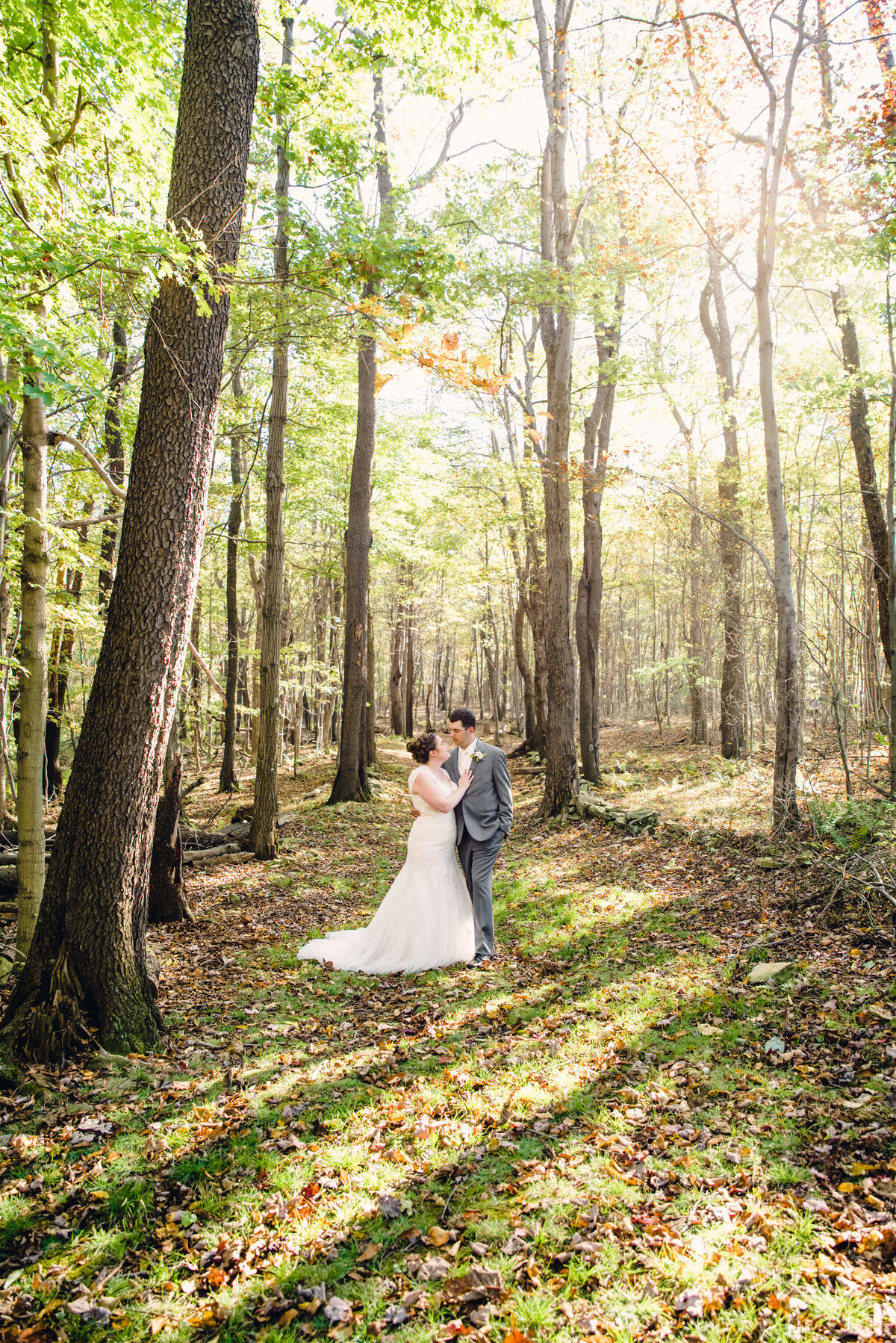 bride and groom kiss in woods at jumonville