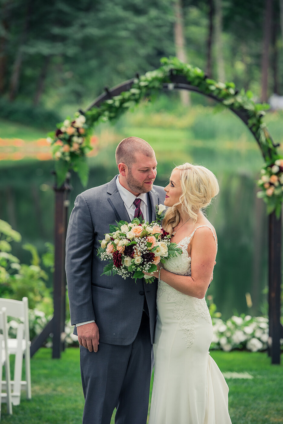 bride and groom under arch