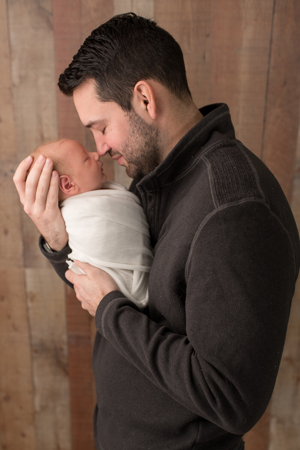 Dad touching son's nose with his nose at studio newborn session in Canton, Connecticut |Sharon Leger Photography | Canton, CT Newborn & Family Photographer