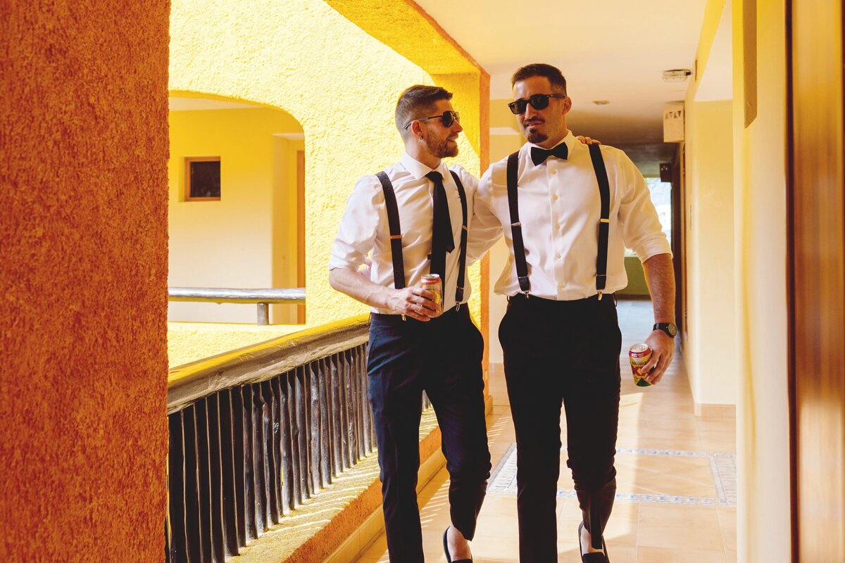 Groom walking with groomsmen in hall at Iberostar Paraiso Riviera Maya wedding