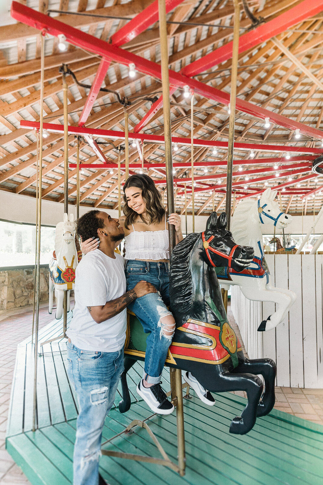 couple on carousel for engagement photos europe