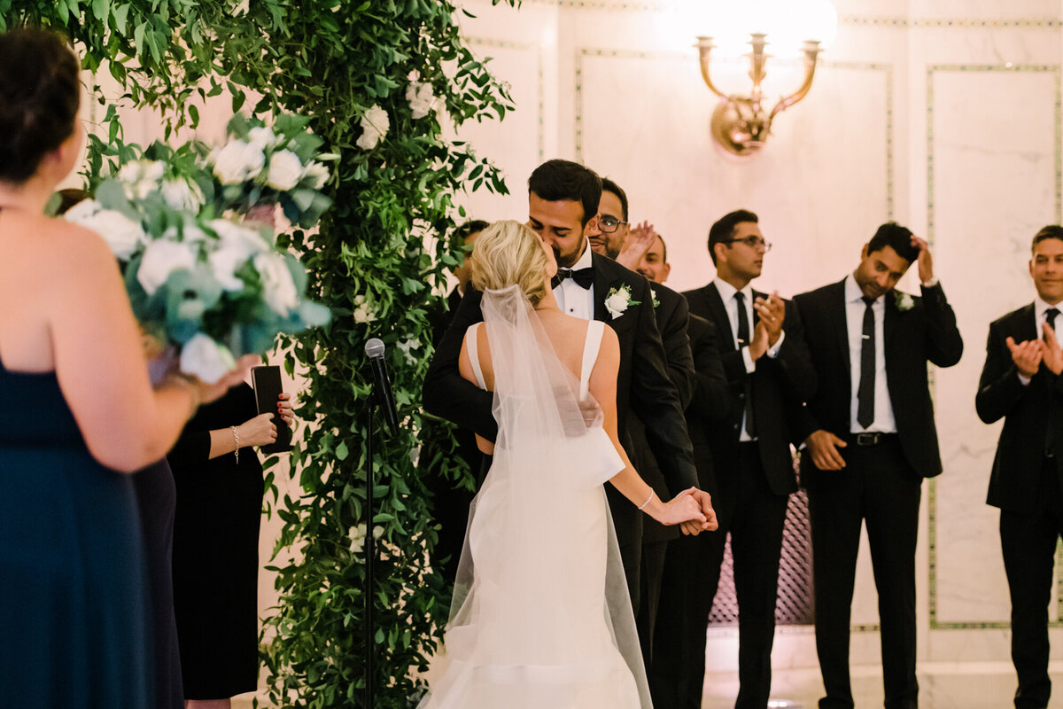 Newlyweds share their first kiss during their wedding ceremony at Chicago Cultural Center