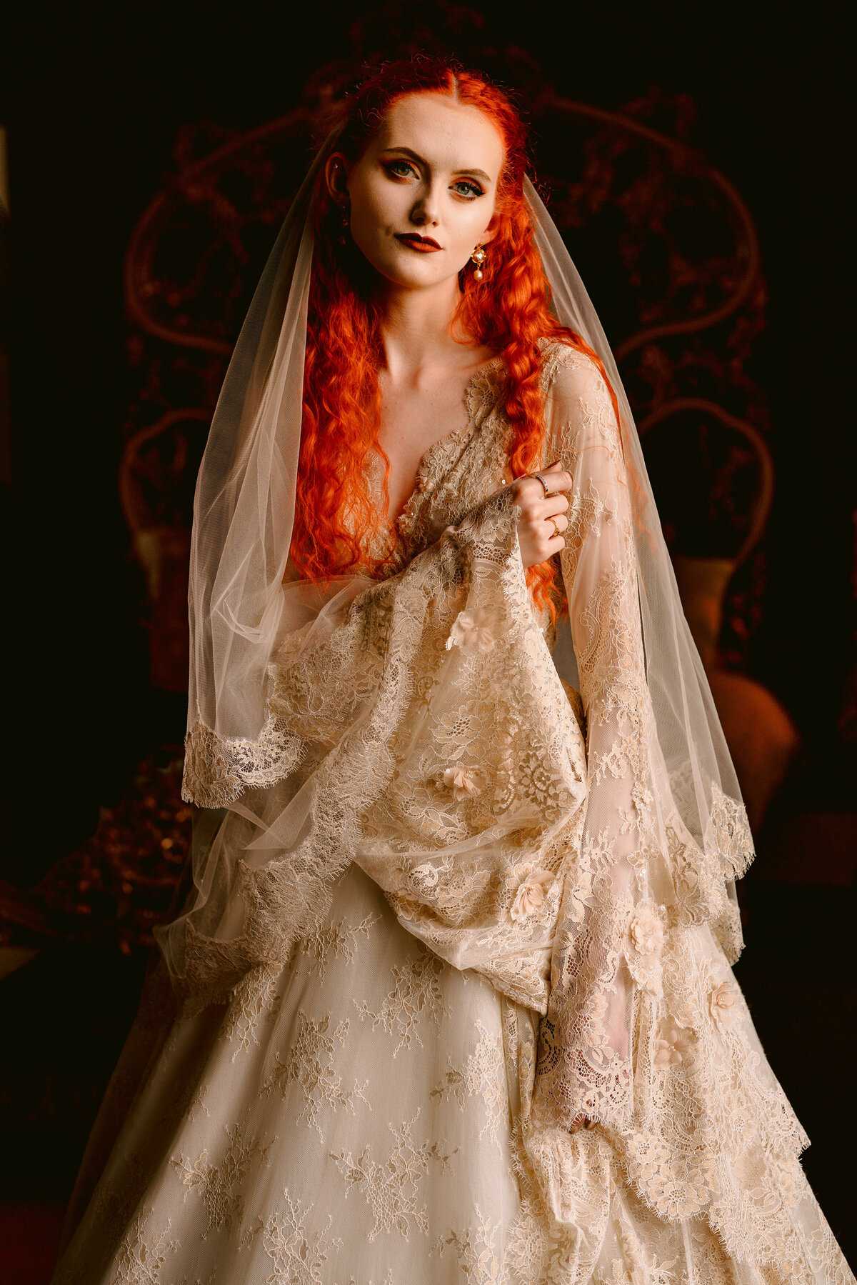 bride in a lace wedding dress in golden light at allerton castle