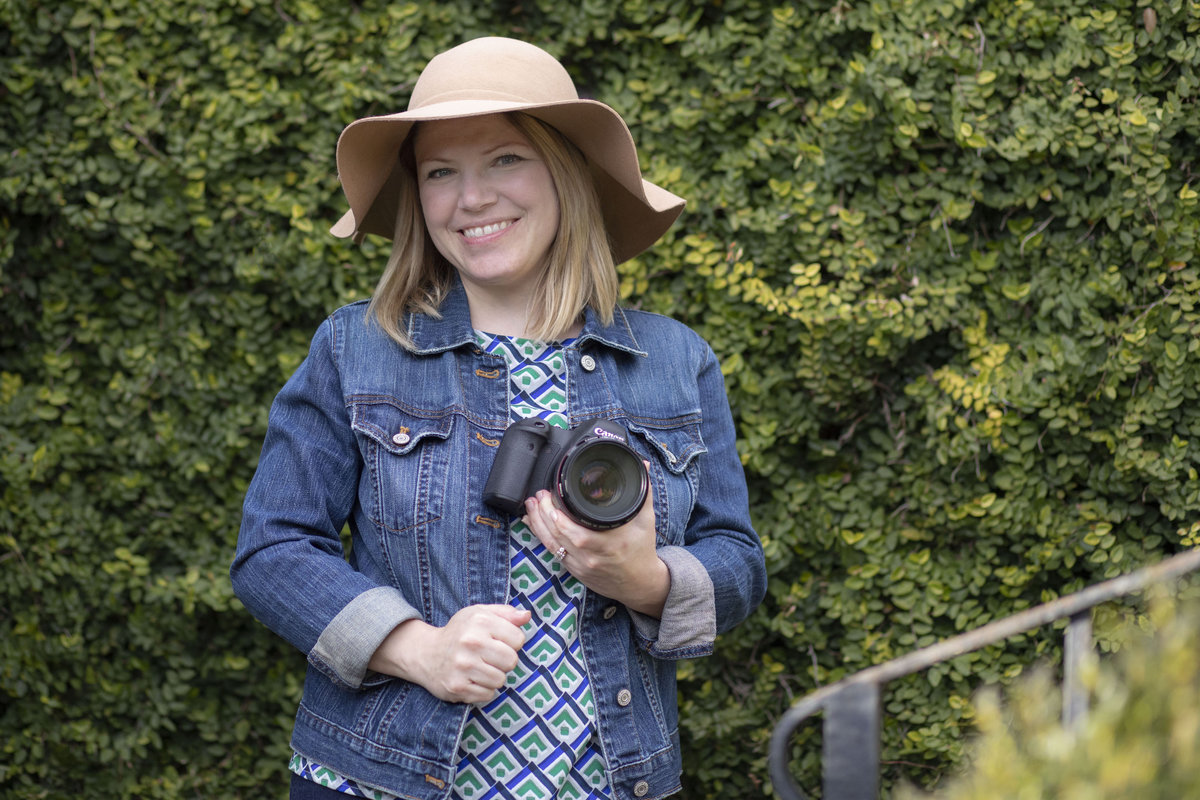 monroe_photographer_a_focused_life_photography_personal_brand_photo_branding_athens_founders_garden_photographer_smiling_holding_camera_hat