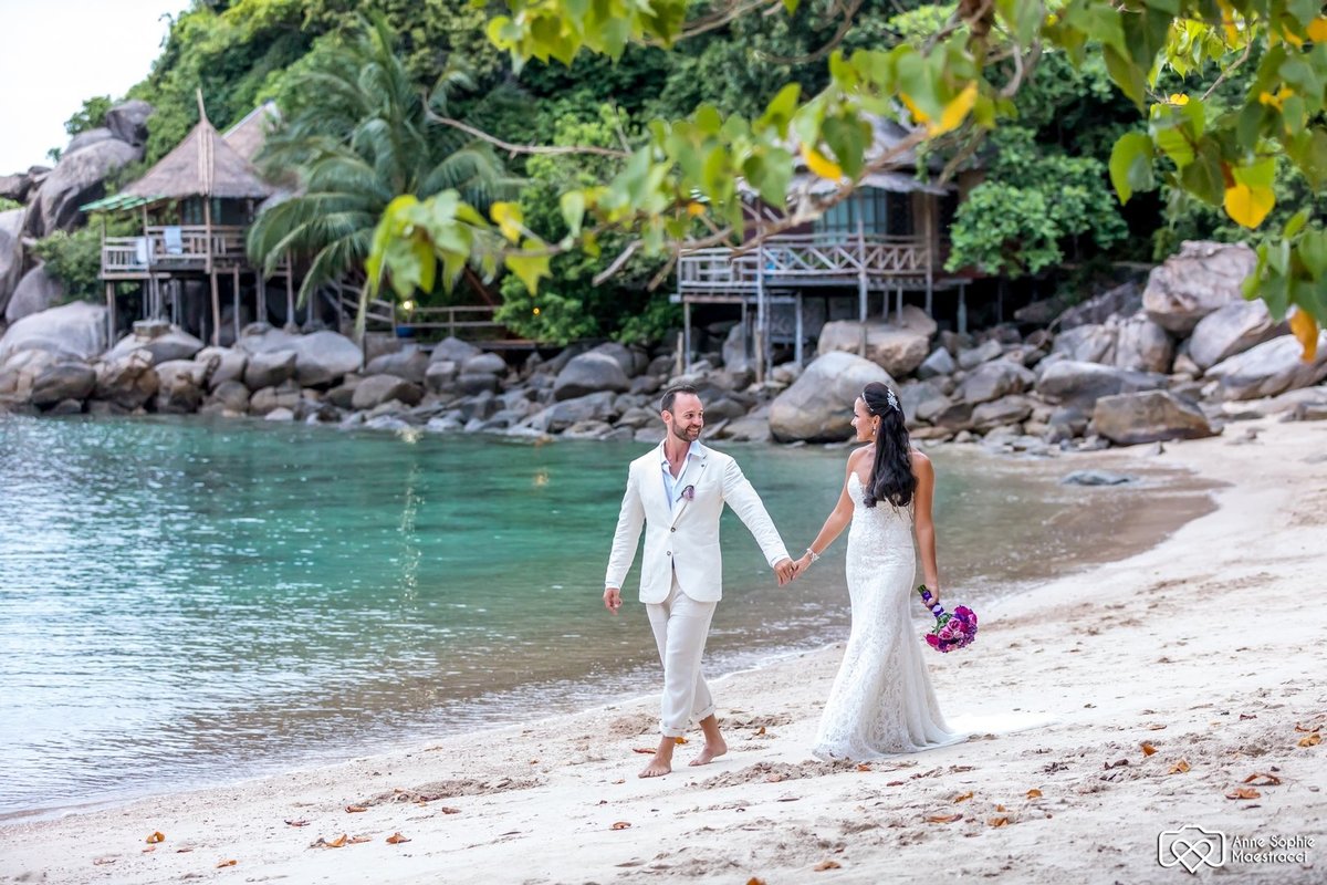 Bride and Groom walking on the beach