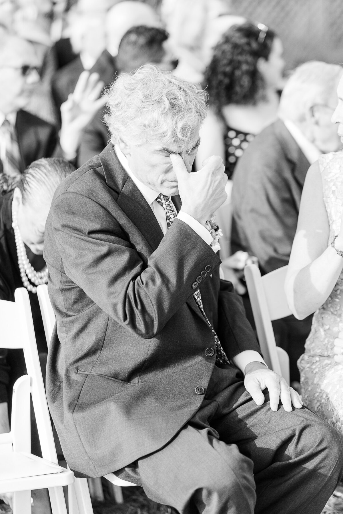 Bride's grandfather wipes a tear during the Madison Beach Hotel wedding ceremony. Captured by best New England wedding photographer Lia Rose Weddings.