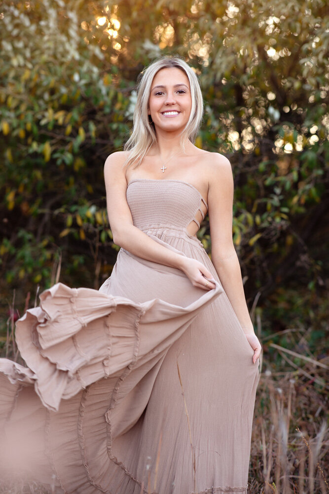 Senior session of young woman wearing a dress