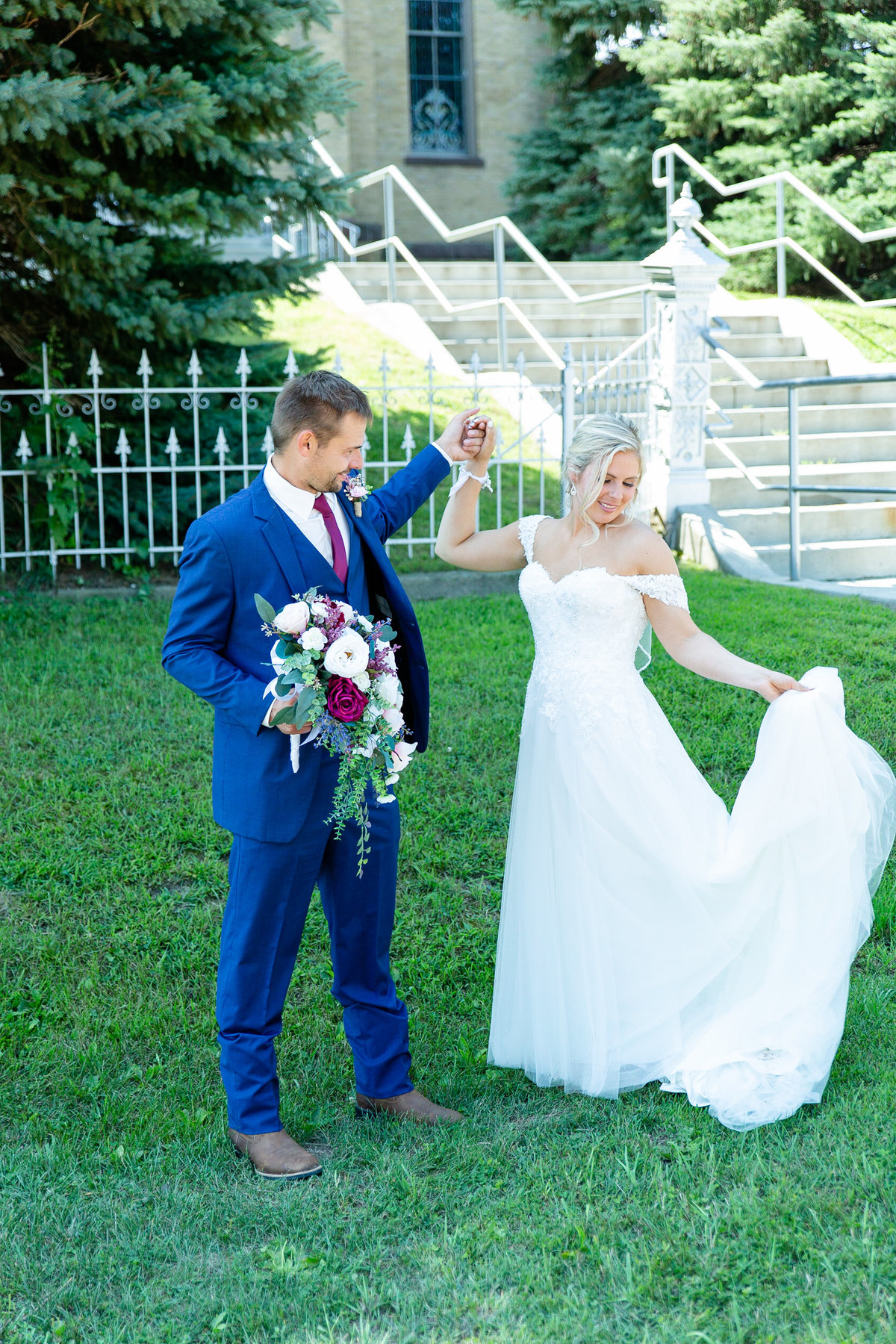 Groom admires bride and her wedding dress