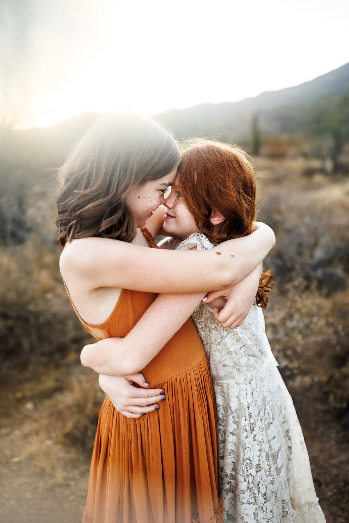 red head freckeled sisters hugging