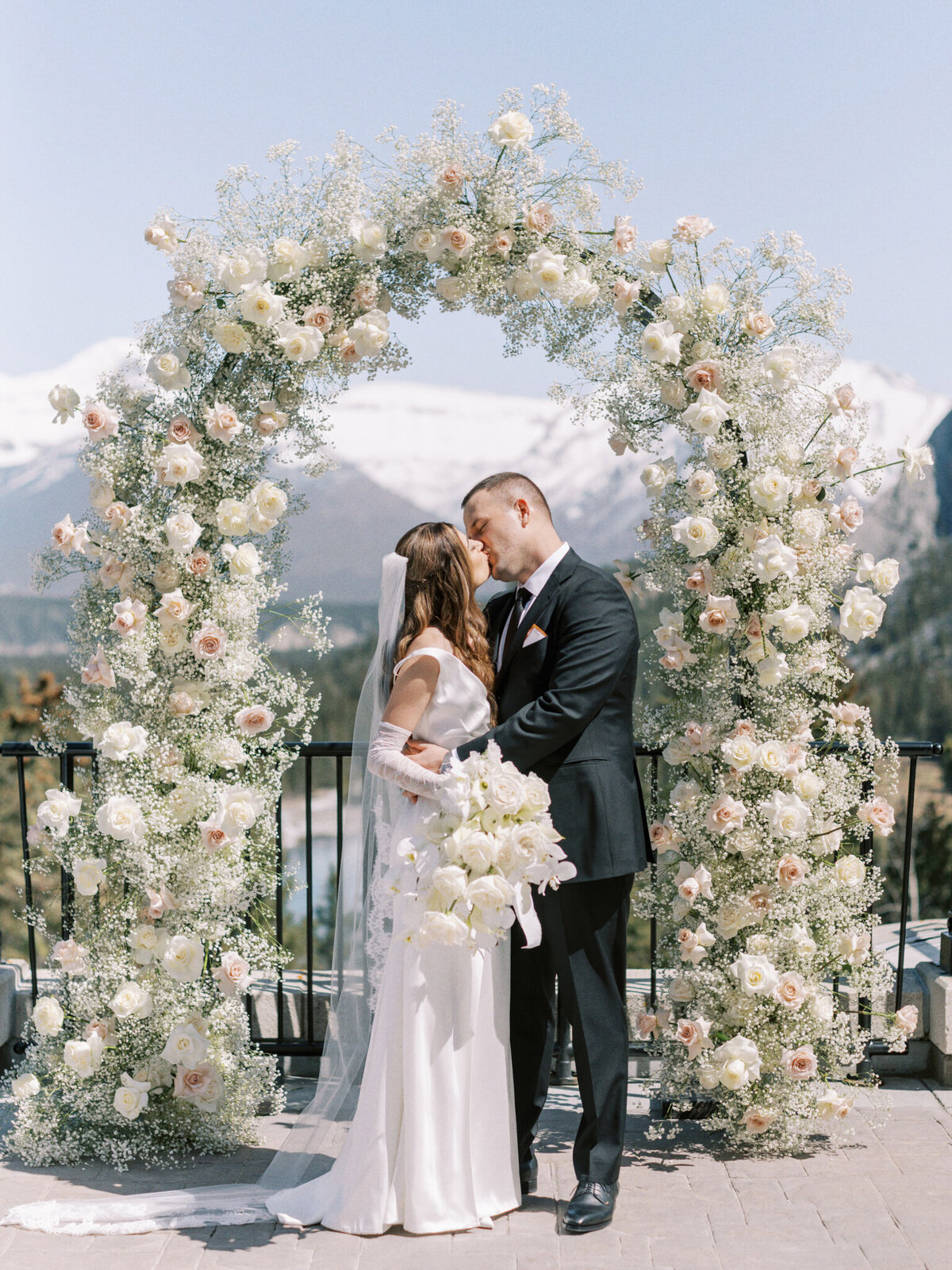 Stunning and romantic ceremony floral arch backdrop by The Romantiks, romantic wedding florals based in Calgary, AB & Cranbrook, BC. Featured on the Brontë Bride Vendor Guide.