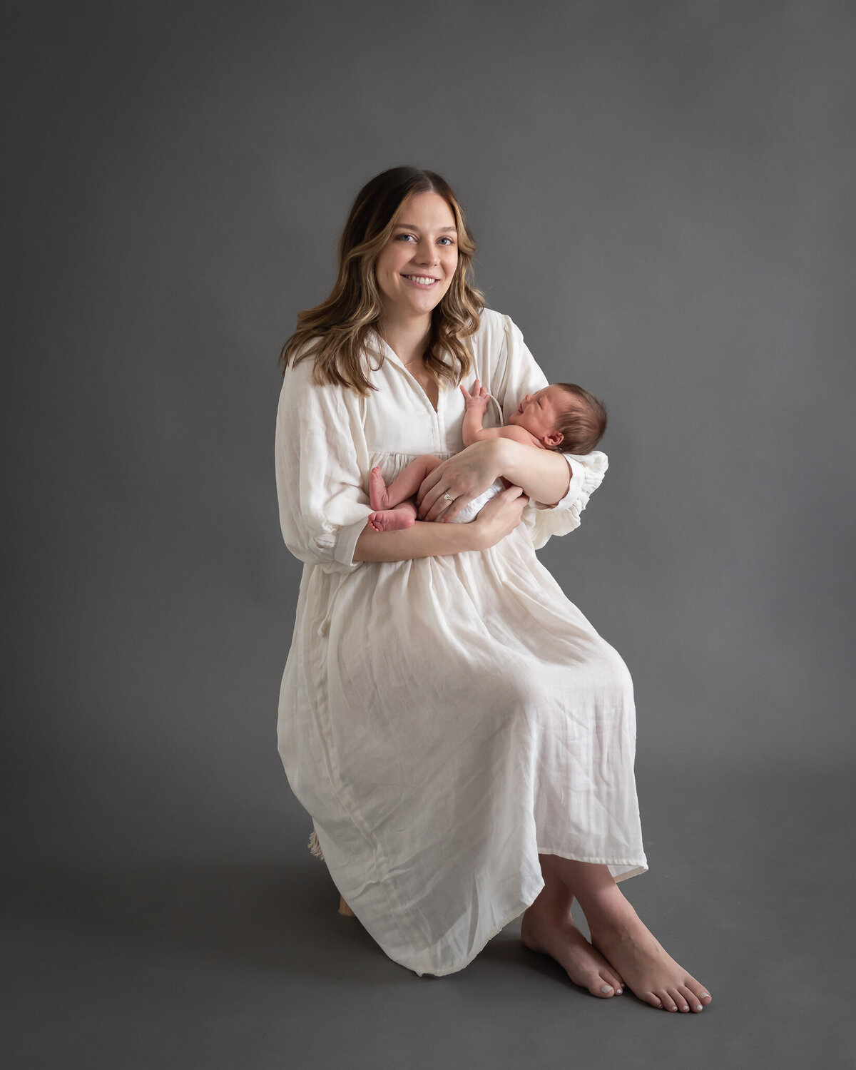 gorgeous portrait of mom holding baby, in-studio
