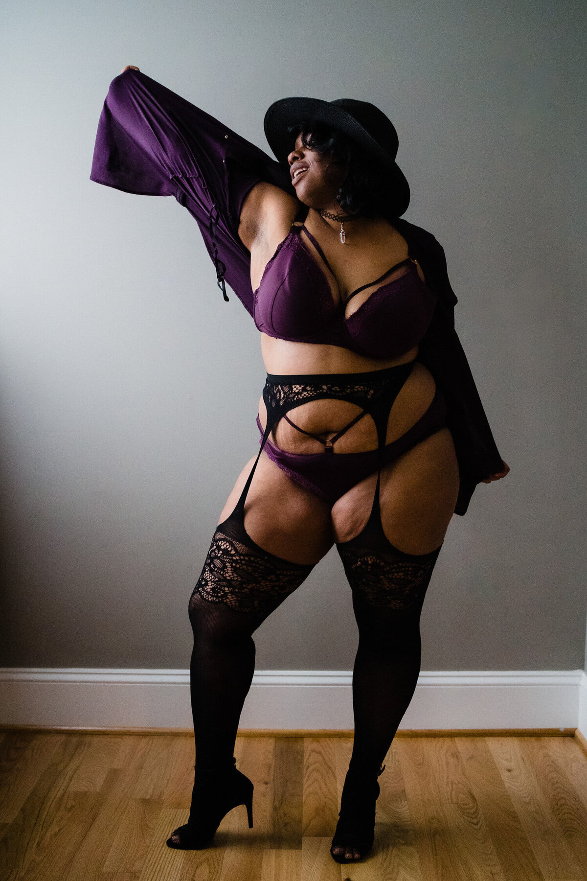 A person in lingerie with one arm outstretched.