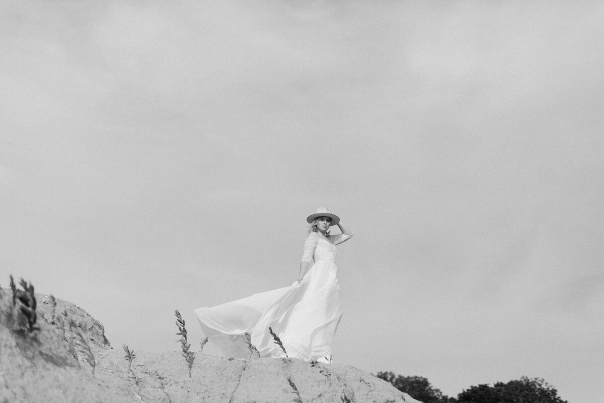 bride on mountain with dress  flowing in the wind