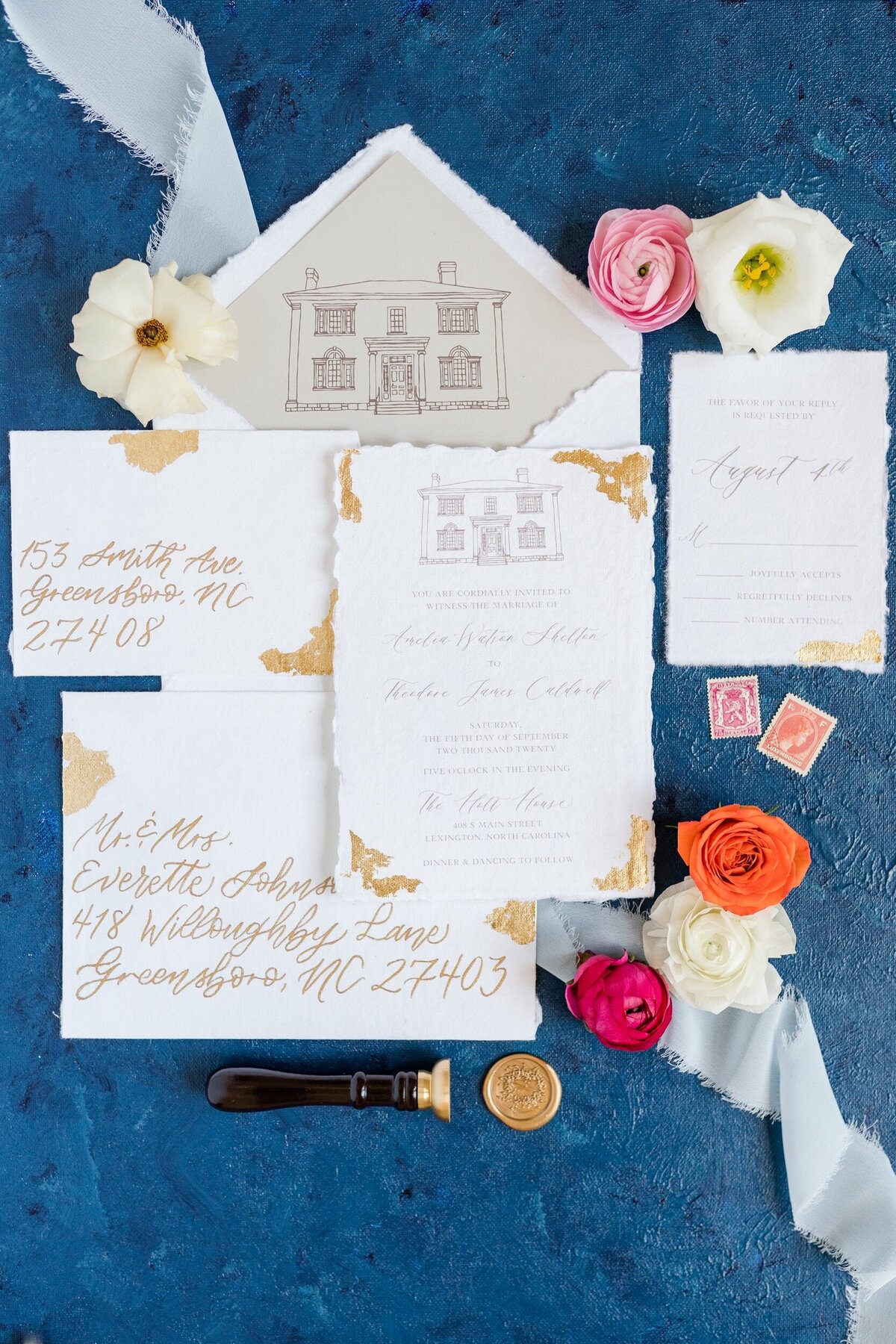 A flat lay photo of a calligraphed invitation suite at a Charlotte, NC wedding.