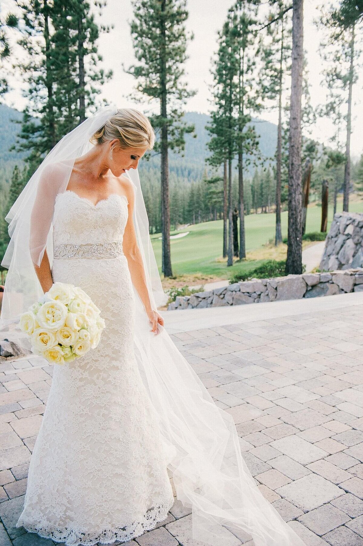 bride with veil  and white bouquet Martis Camp