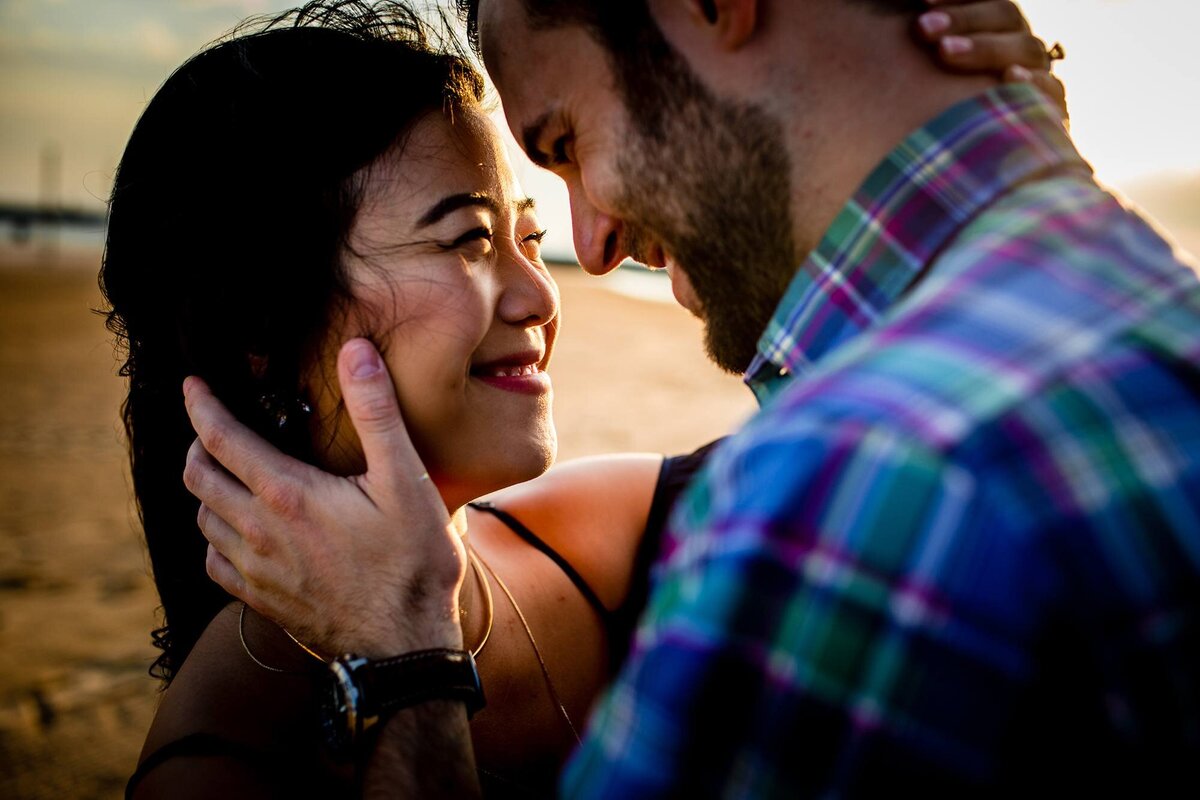A couple embraces during a North Avenue beach engagement session.