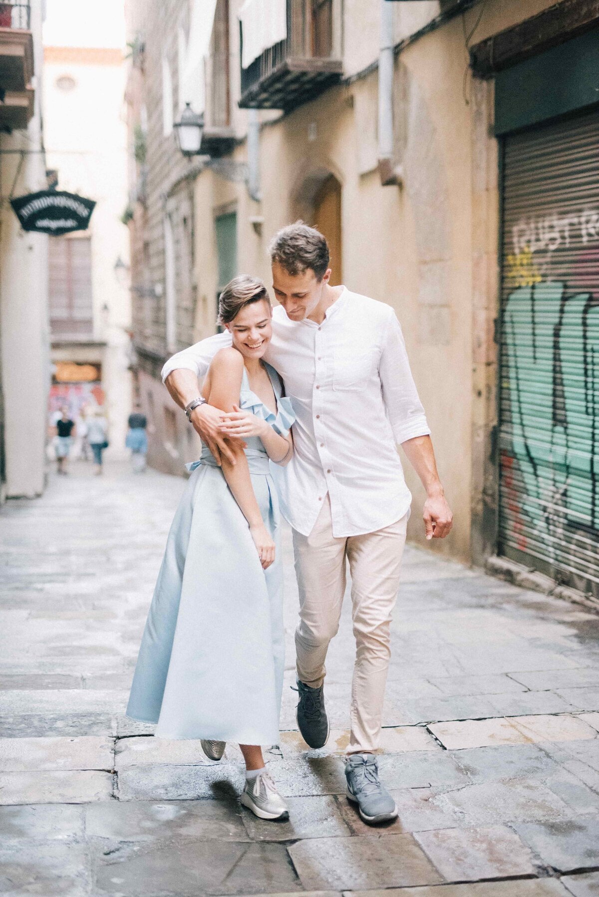 couple-walking-down-cobblestone