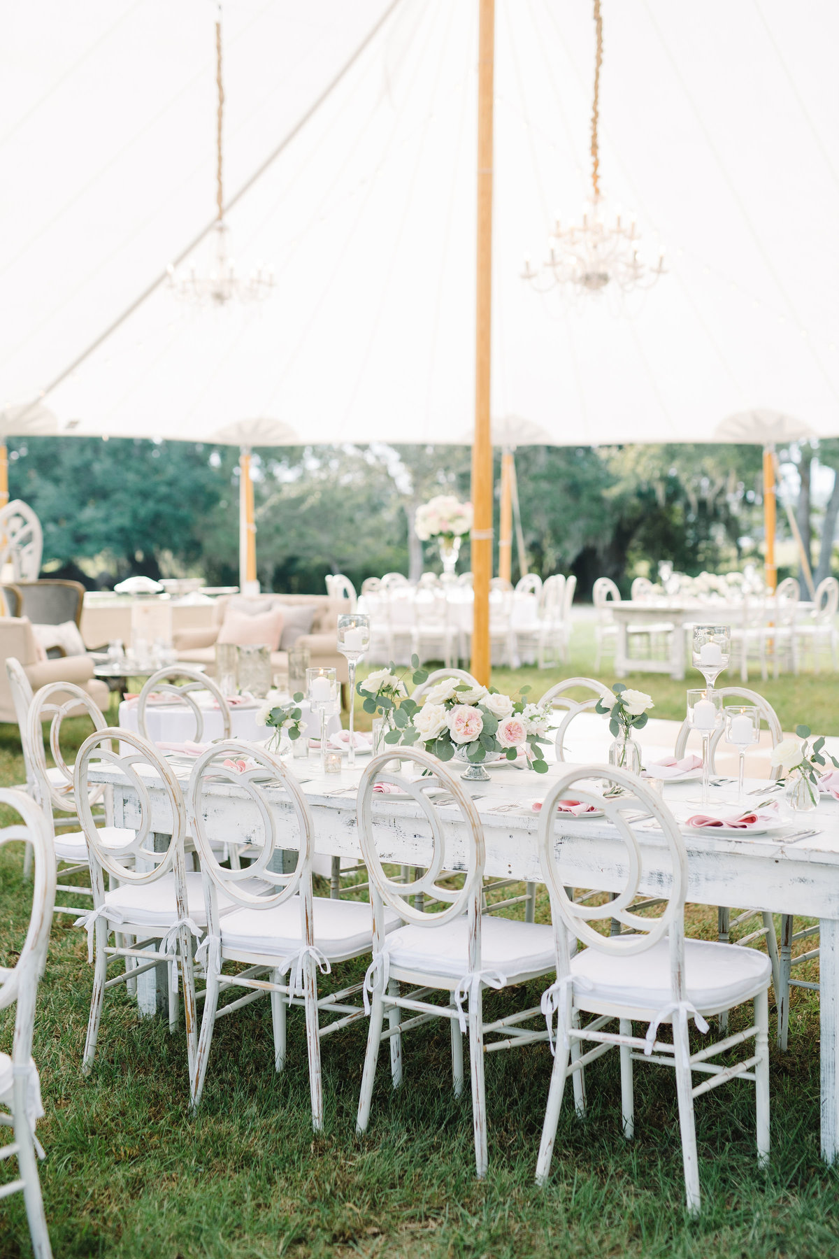 White and Blush Wedding Reception White Chloe Chairs wit Crystal Chandeliers under Sailcloth Tent at Boone Hall