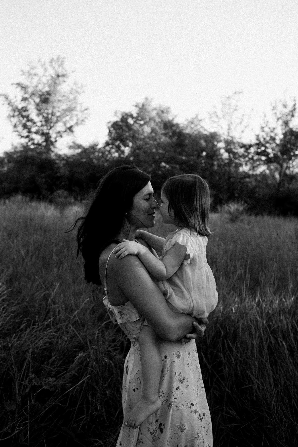 Mom holding daughter during session