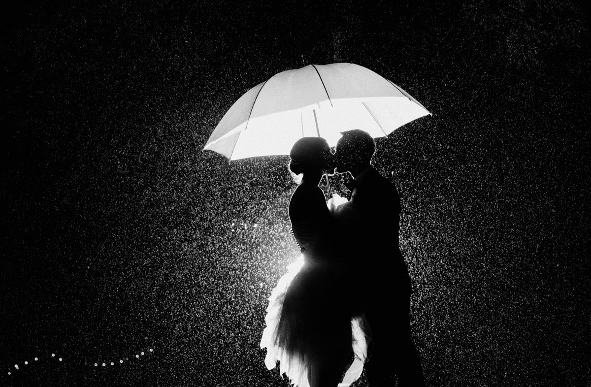 creative rainy day black and white dramatic light kiss wedding bride and groom
