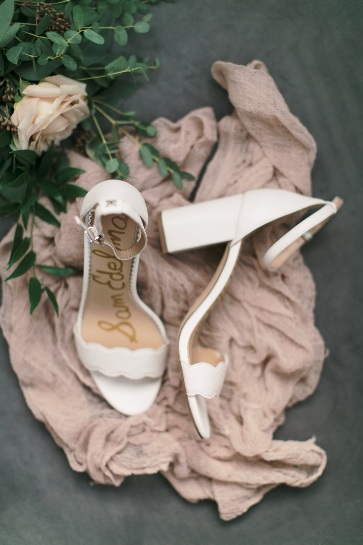 white bridal shoes with greenery during bridal details shots