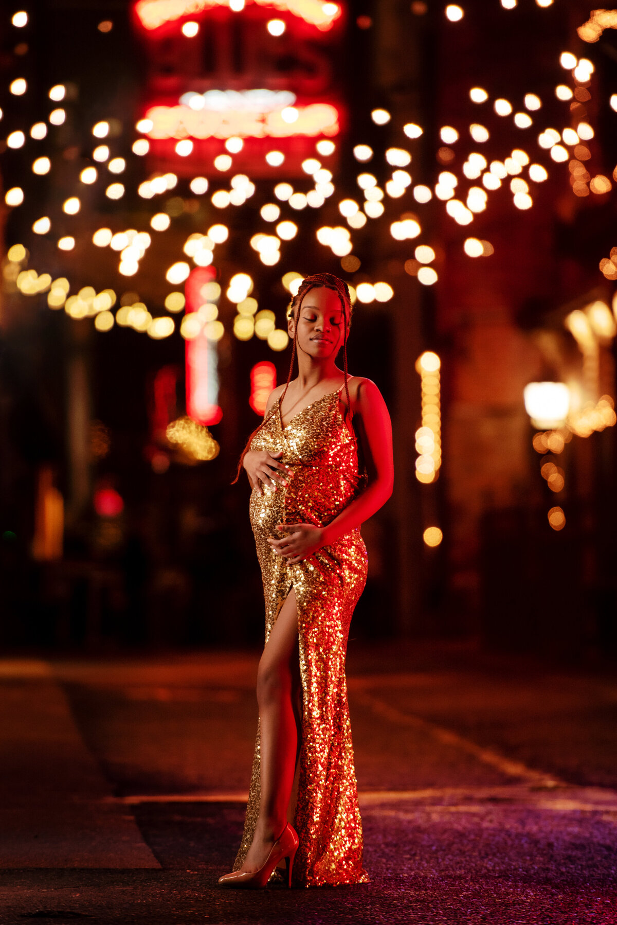 st-louis-maternity-photographer-pregnant-mom-in-gold-sequin-gown-on-nashville-at-night-with-neon-lights