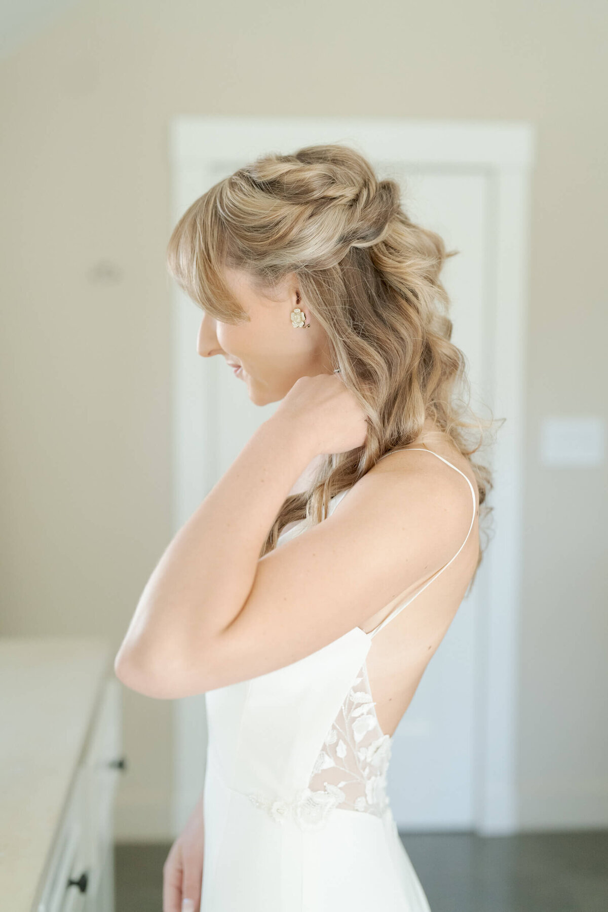 Bride in Sonoma county poses in a backless wedding dress.