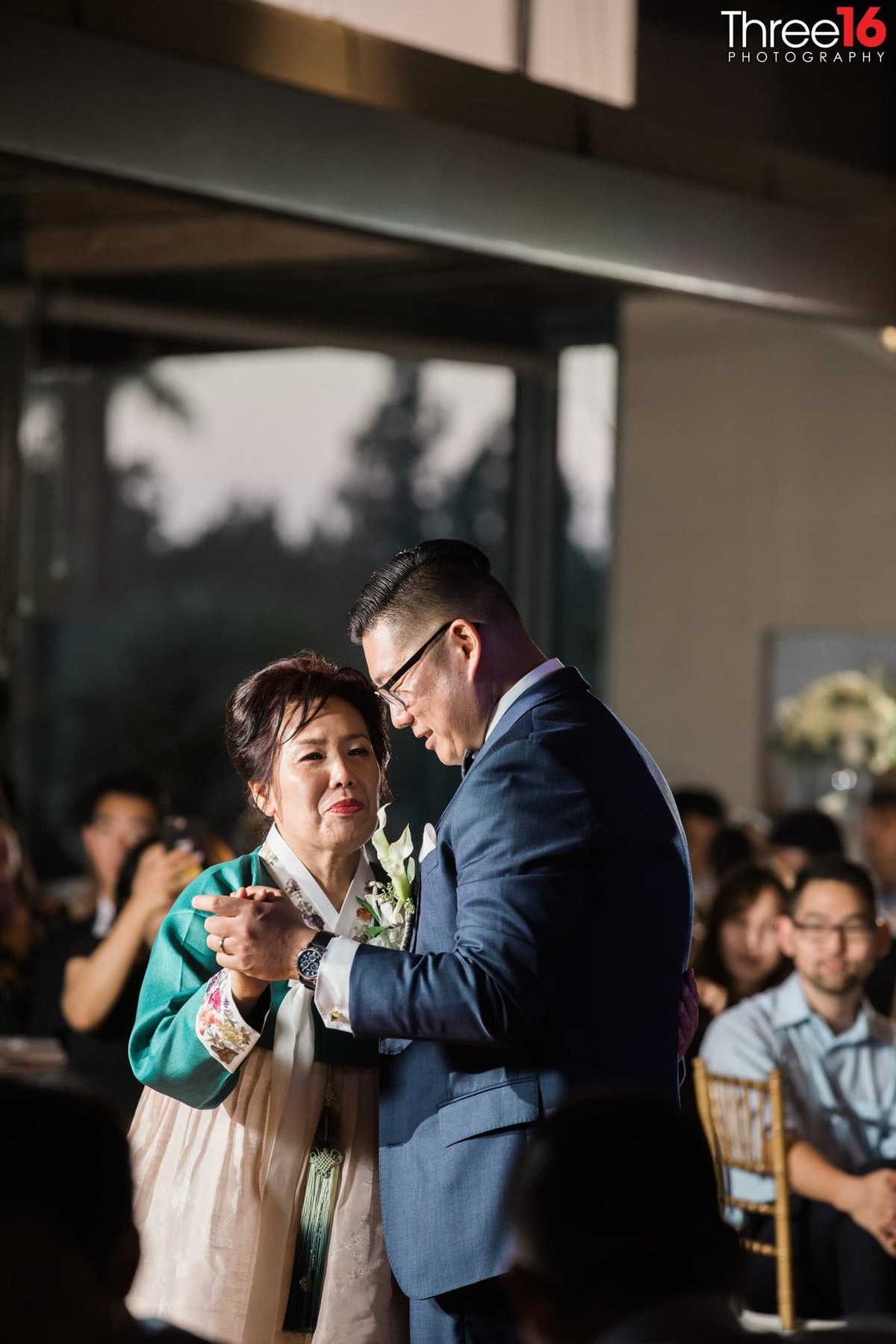 Groom dances with his mother at his wedding