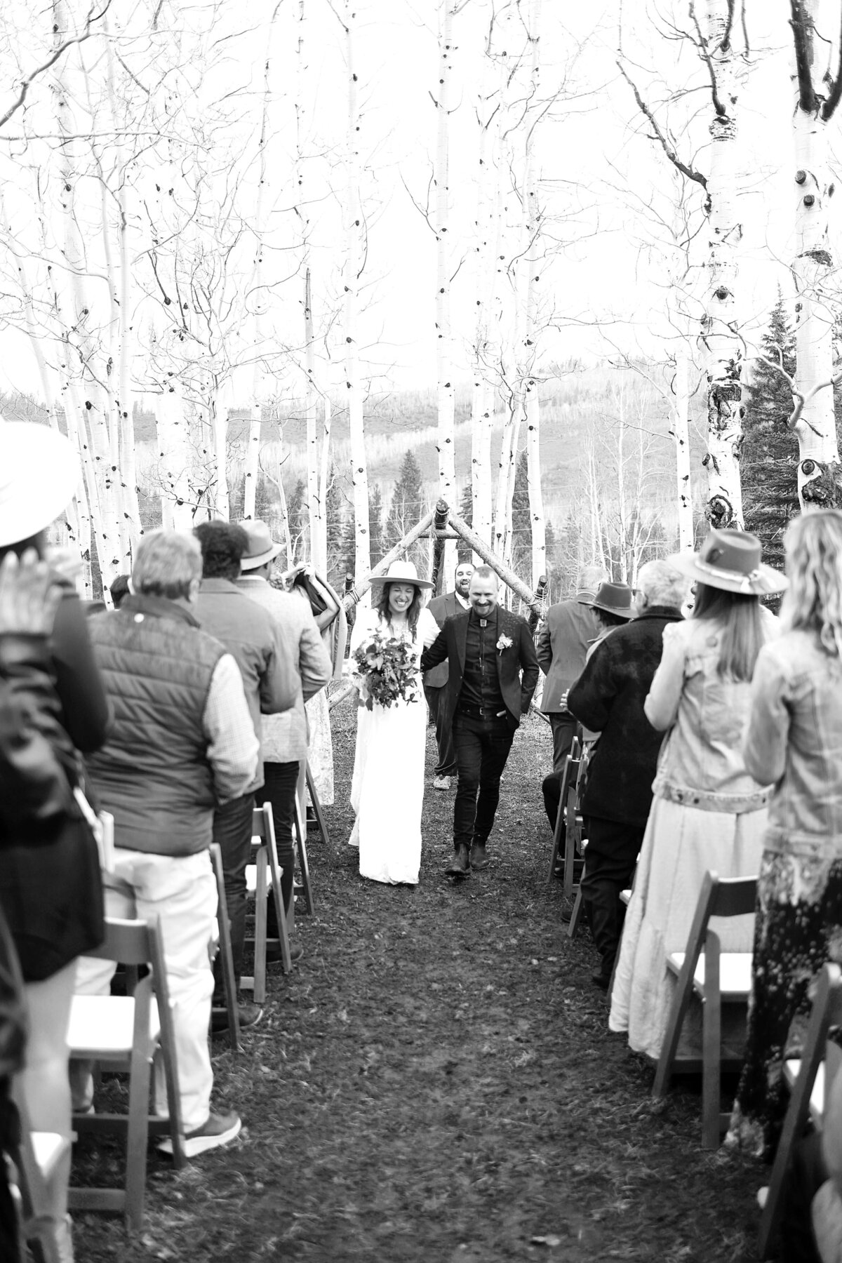 Young couple, laughs as they come back after saying their vows in front of their friends and family in Aspen, Colorado,