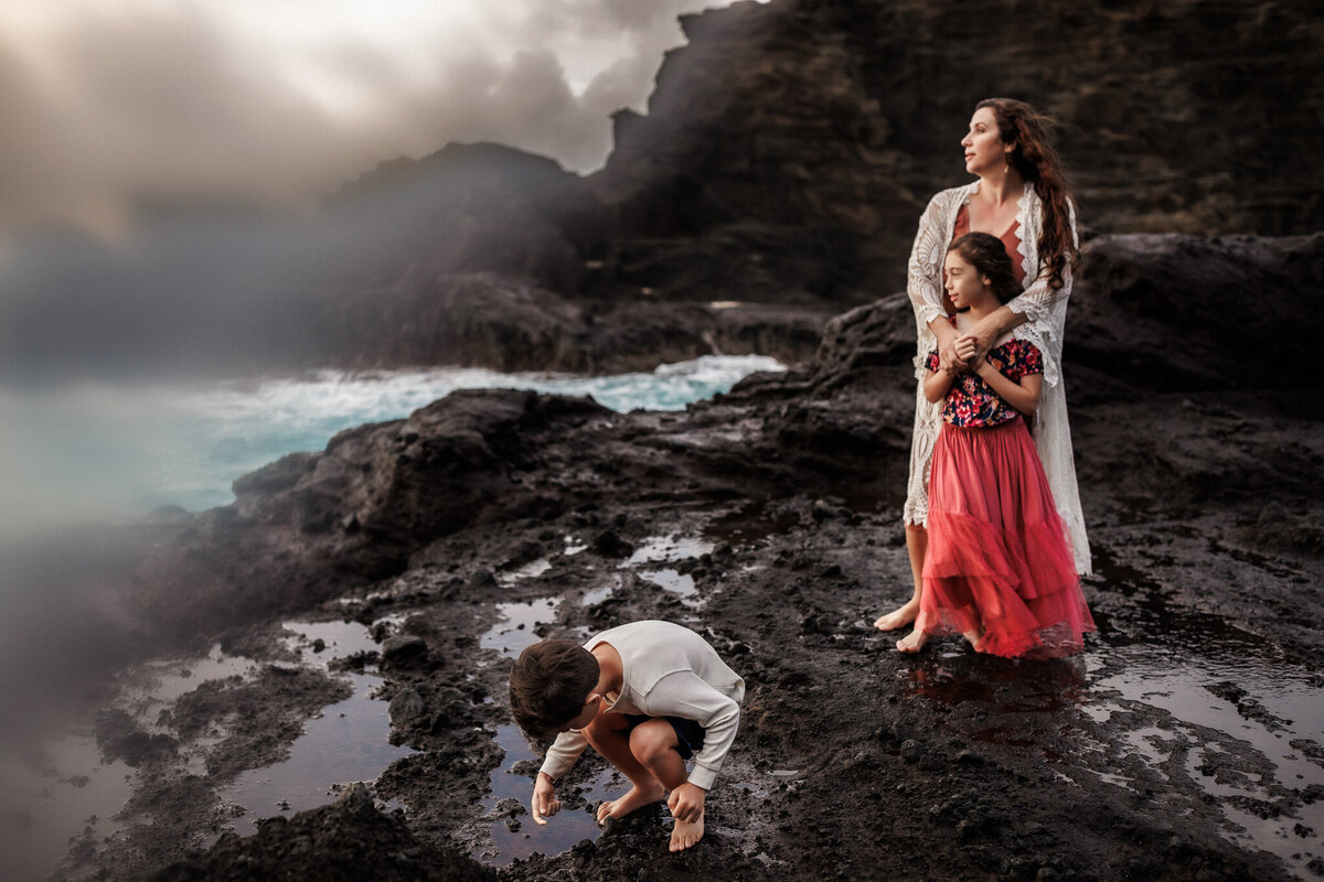 family on rocky shore Hawaii