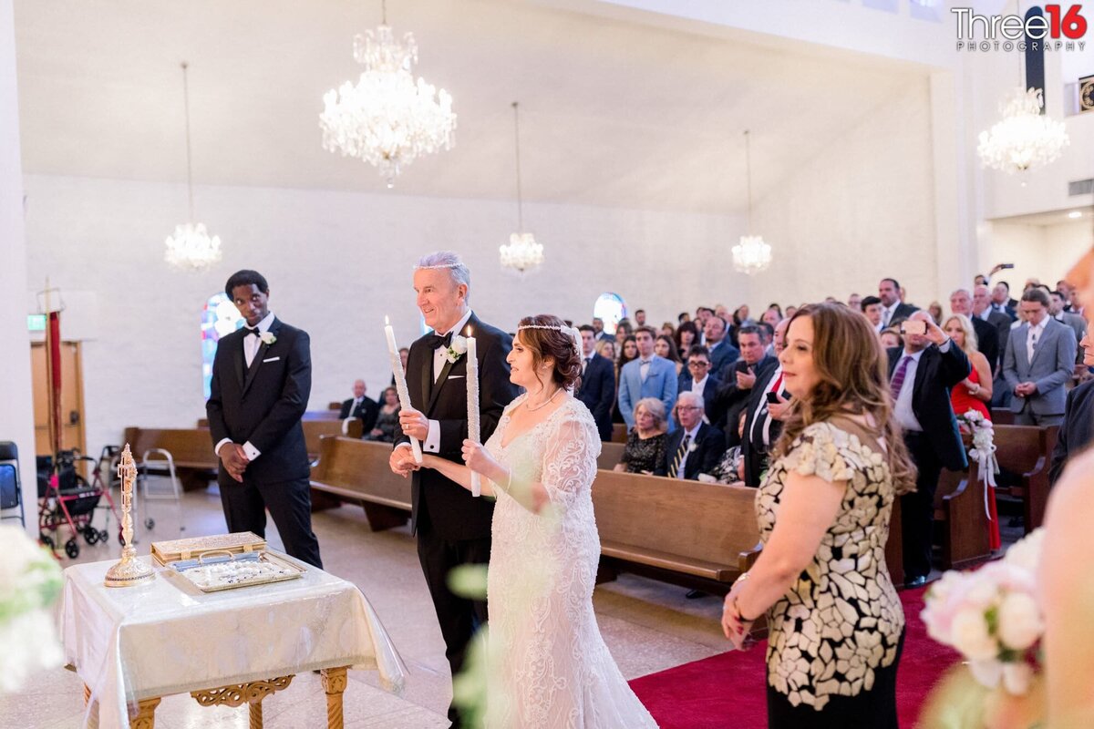 Bride and Groom face the altar during a candle lighting celebration