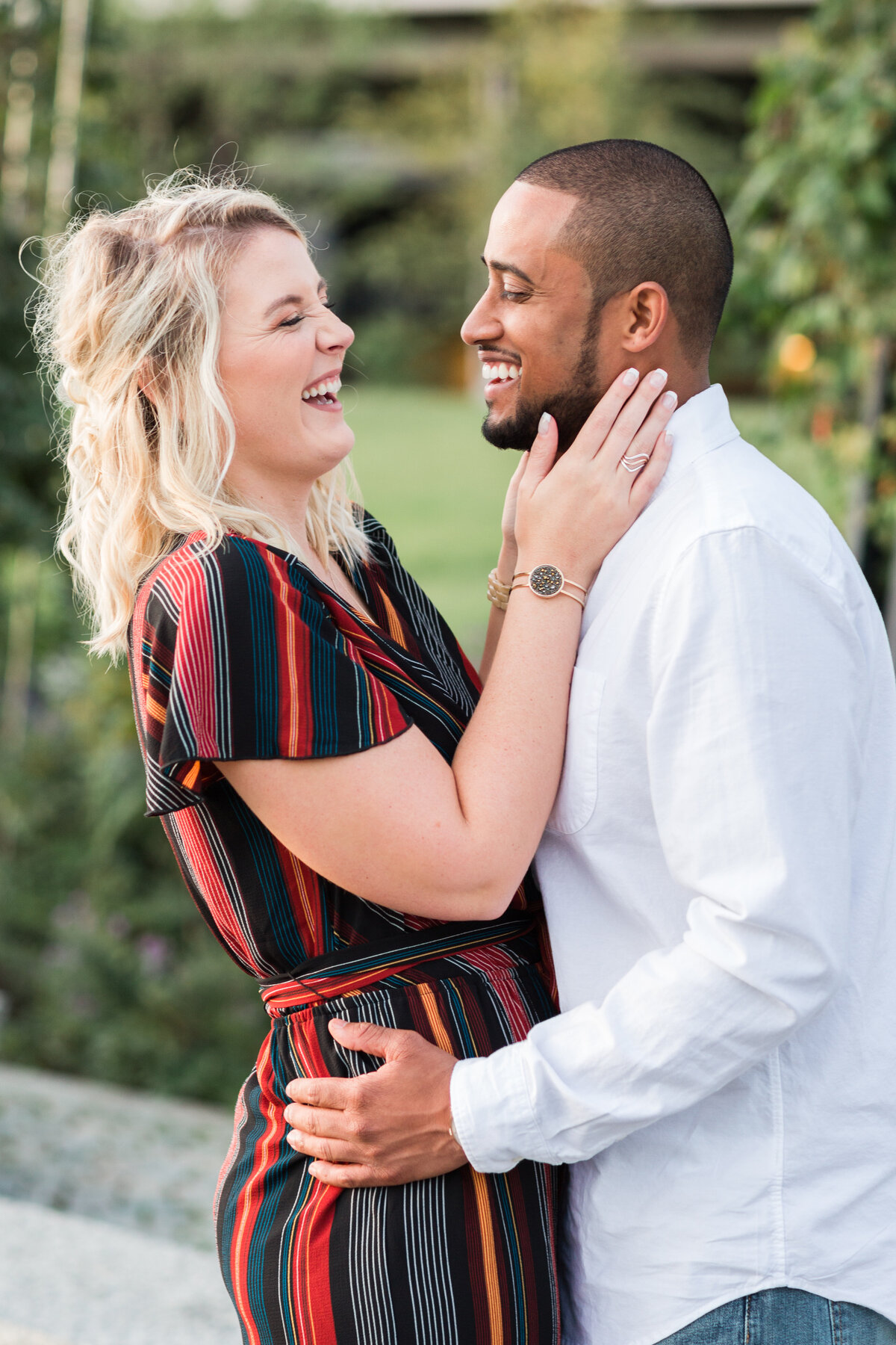 interracial couple laughing during engagement session