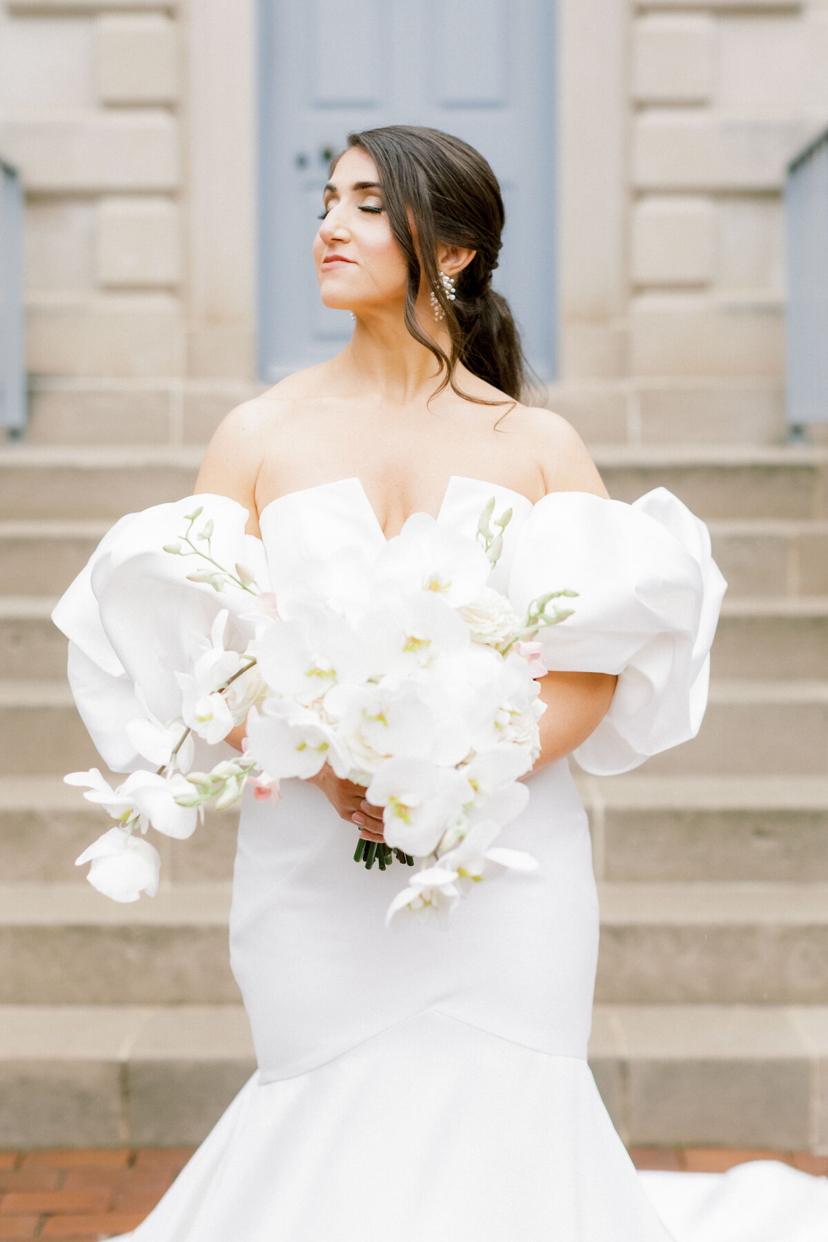 Fine art wedding photography of modern bride holding bouquet of white flowers
