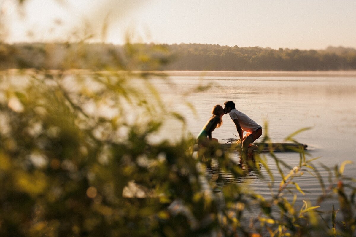 Couple takes engagement pictures on a paddle board