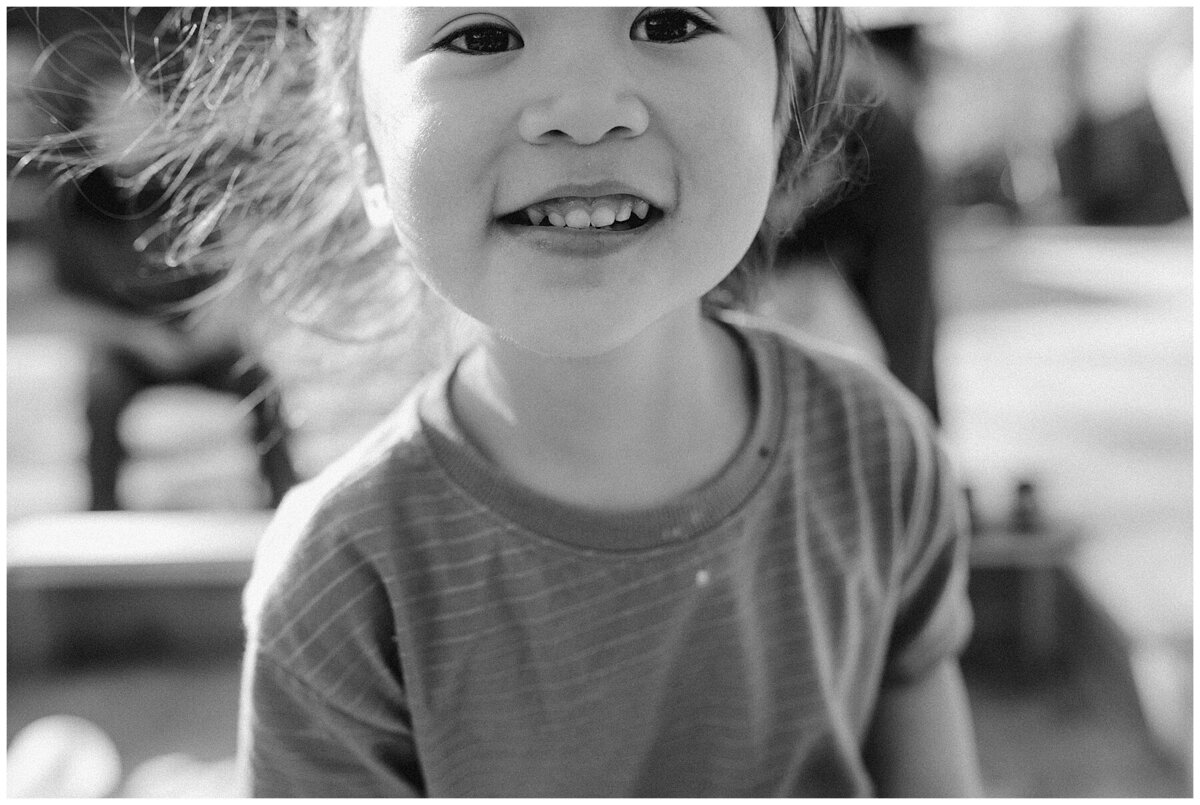 Child with smiliing face at  garden family session in Austin by Amber Vickery Photography