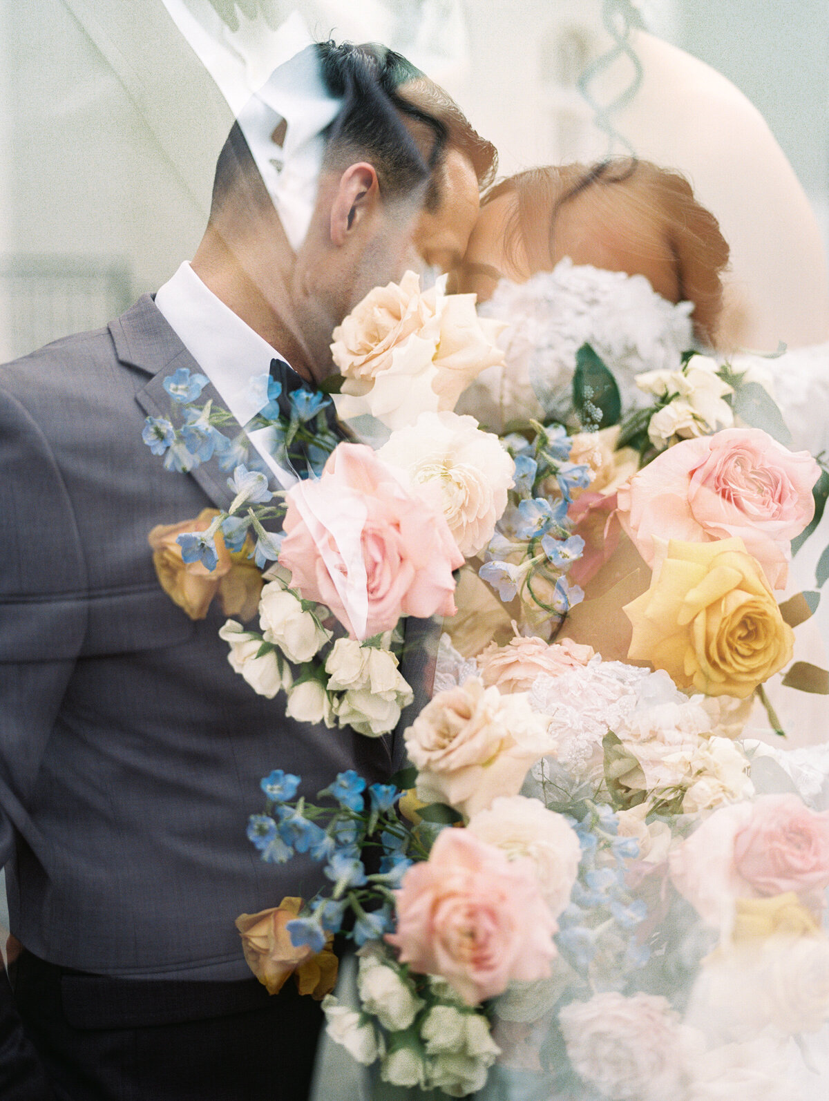 Bride and Groom with colorful flowers at garden party wedding at Chateau Nouvelle
