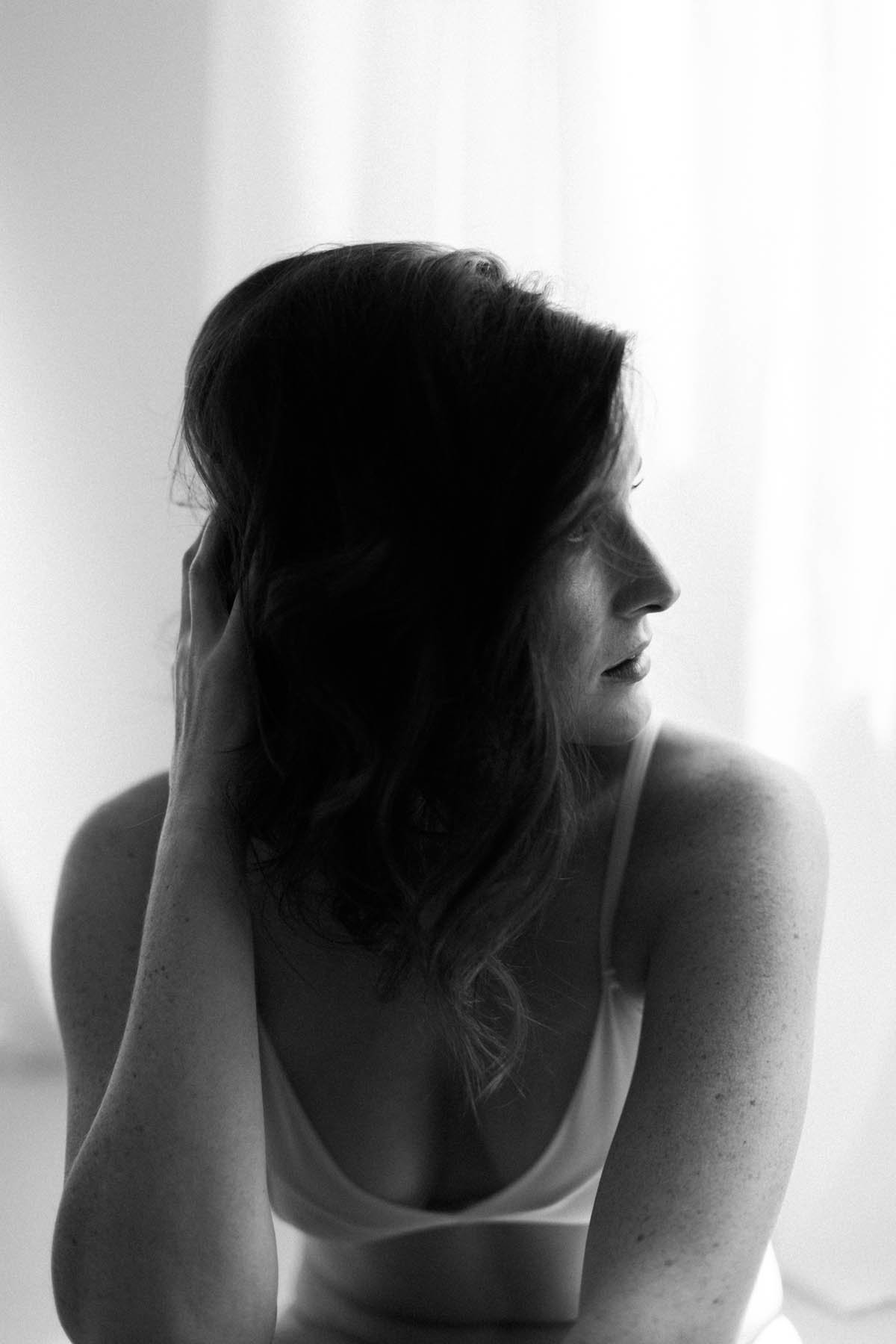 black and white image of a woman during boudoir session