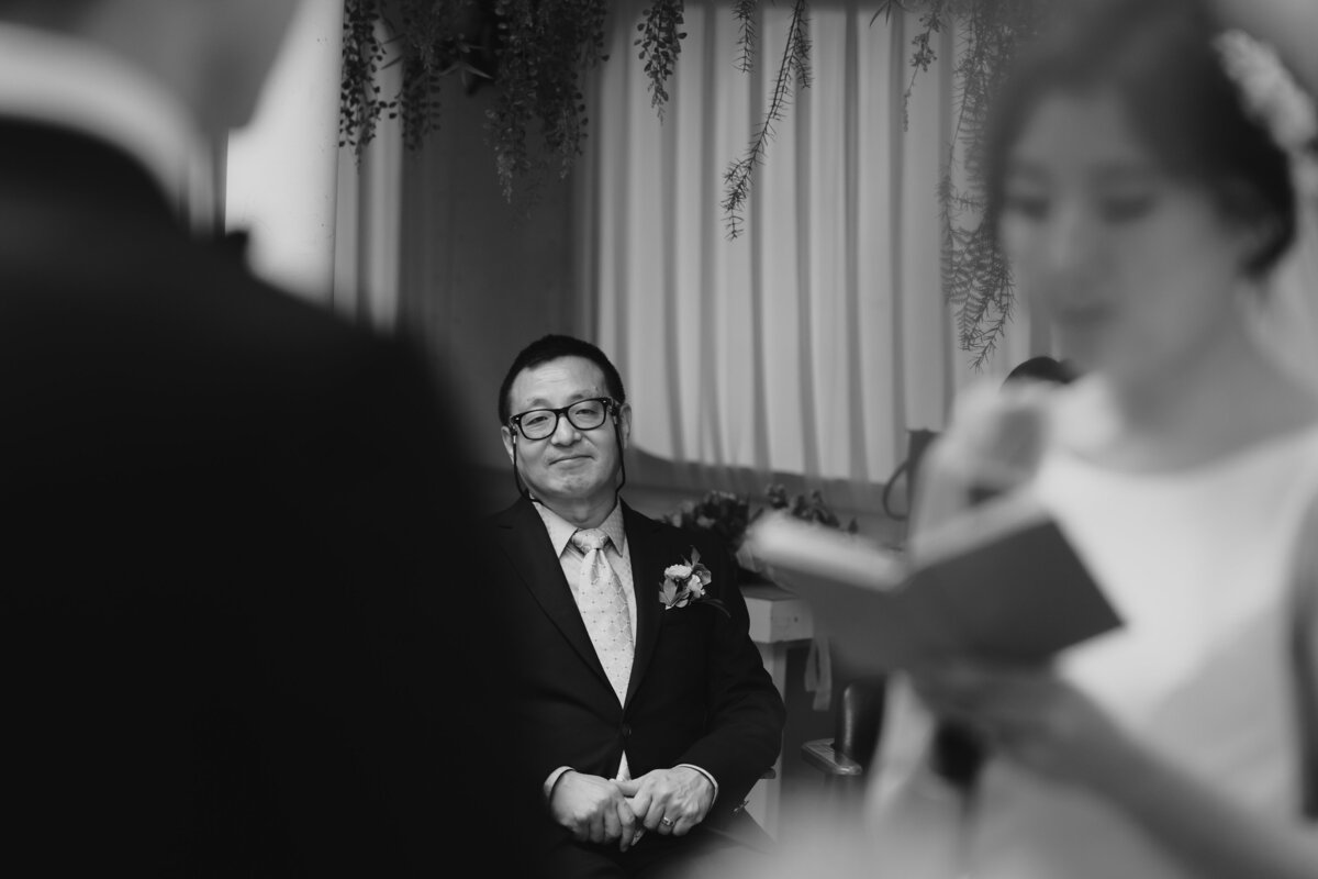the father smiling while listening to his daughter's vow